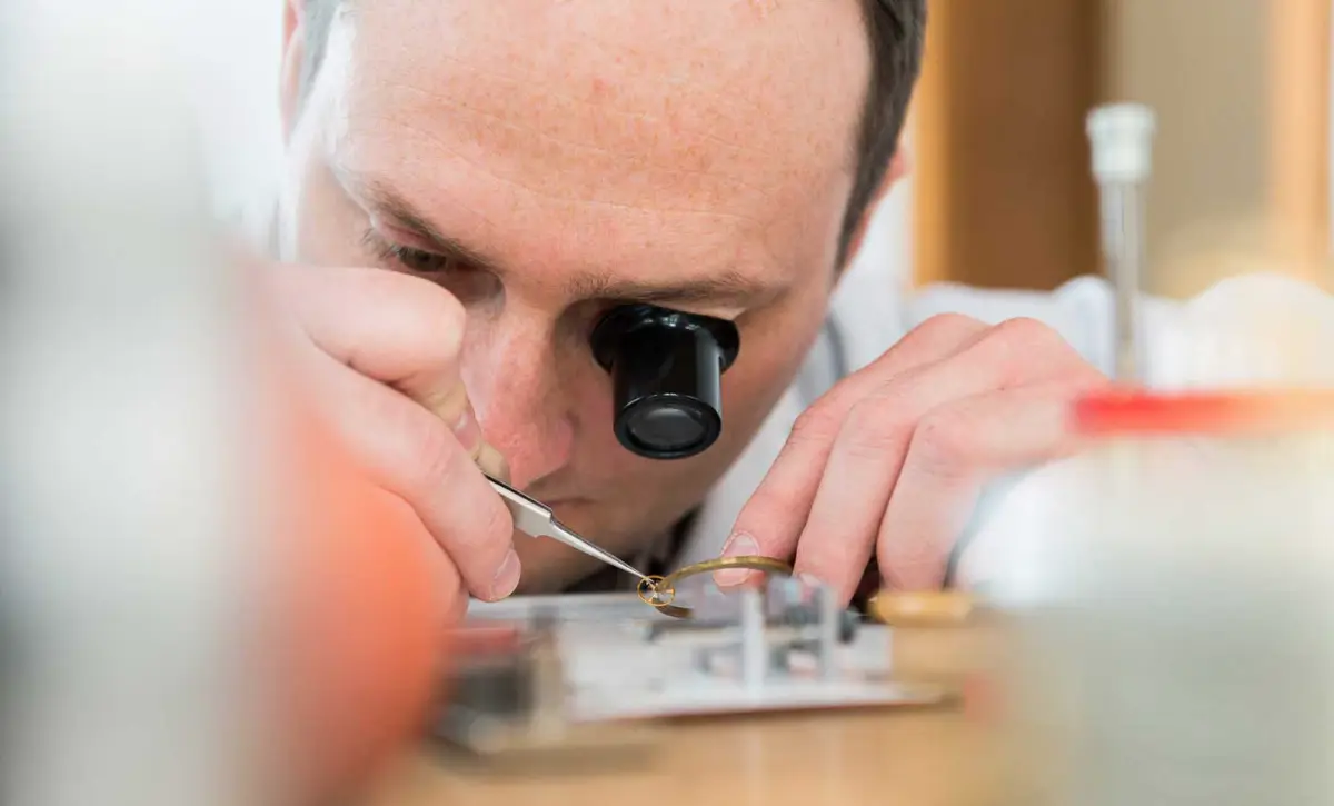Daniel Malchert at the bench setting a balance spring